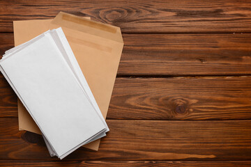 Stack of letters on wooden background