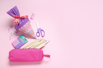 Purple school cone with different stationery on pink background