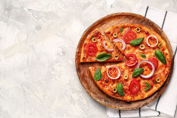 Wooden plate with tasty pizza on grunge grey background