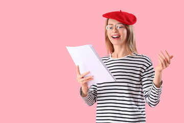 Female author with paper sheets on pink background