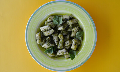 Gnocchi basil pesto on the table.