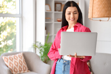 Young woman using laptop at home