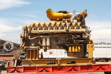 Large industrial machinery on red platform for transport