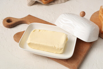 Ceramic dish with fresh butter on light table