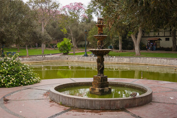 Serene park with central fountain and surroundings.