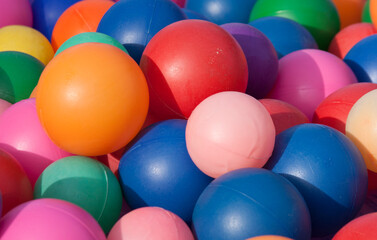 Colorful array of plastic balls tightly packed together.
