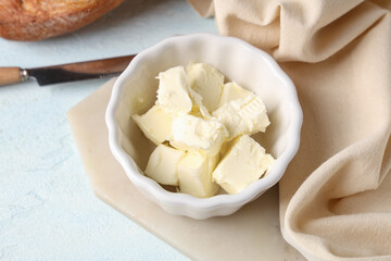 Bowl of fresh butter and napkin on light table