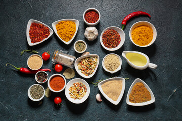 Composition with various aromatic spices on dark color background