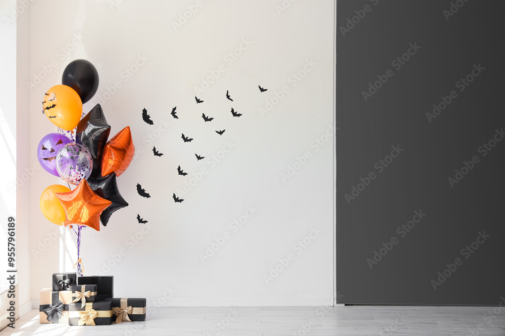 Wall mural halloween balloons with gift boxes near black and white wall in room