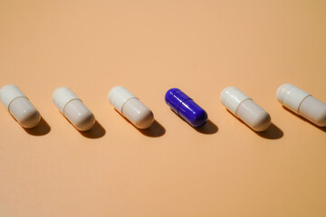 medicine capsules in a line on light beige, Medical and healthcare, dietary supplements and vitamins