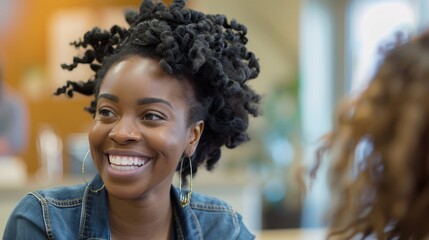 Obraz premium Smiling Woman with Natural Curly Hair in Casual Denim Jacket in Bright Indoor Setting