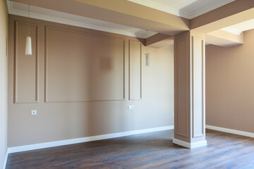 A room with a white wall and a brown ceiling