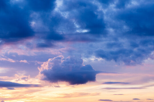 Cloud in the shape of a ship floating in sunset sky