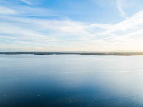 Aerial view over calm blue coastal lake waters