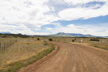 Gravel road through Colorado with mountains background