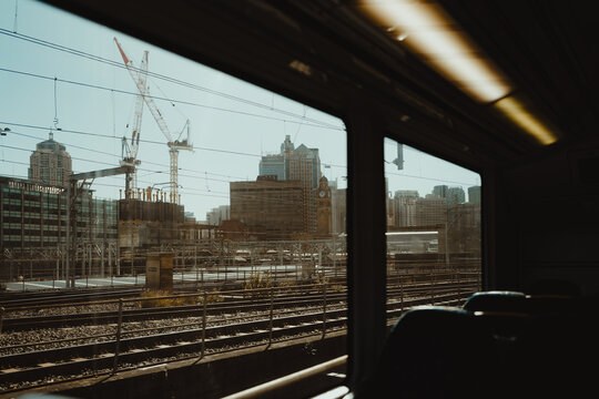 Fototapeta Industrial city view through a train window approaching central station