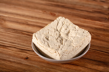 A piece of old tofu on a plate