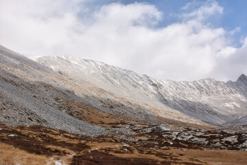 The field road sprinkled with the first snow, bending around the stones, turns into a rocky valley...