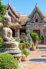 Fototapeta premium Colorful Mosaic Temple in Thailand with Stone Buddha Statue
