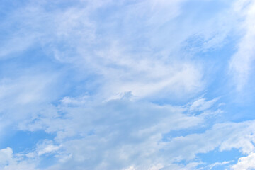 beautiful blue sky and white fluffy group of clouds with sunrise in the morning, natural background