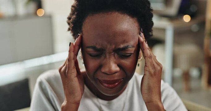 Black woman, face and headache in home from stress, head cold and dehydration on sofa. Female person, discomfort and migraine in living room for crisis, emergency and massage temples for pain relief