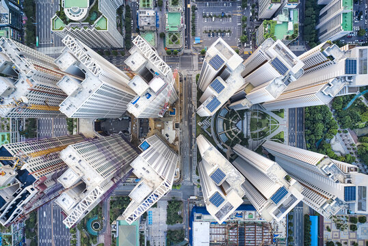 Wonmi-gu, Bucheon-si, Gyeonggi-do, South Korea - July 28, 2021: Aerial and top angle view tower cranes and roofs of highrise apartments under construction near Bucheon Central Park in summer