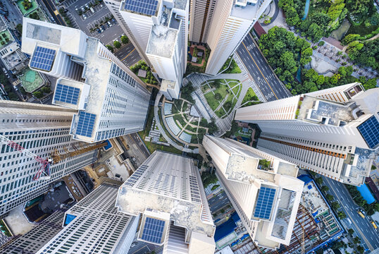 Wonmi-gu, Bucheon-si, Gyeonggi-do, South Korea - July 28, 2021: Aerial and top angle view tower cranes and roofs of highrise apartments under construction near Bucheon Central Park in summer