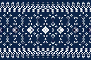 Fototapeta premium Vintage cross stitch traditional ethnic pattern on blue background. floral pixel art embroidery.Elegance background abstract Aztec seamless pattern for fabric,cloth,dress,carpet,curtain,sarong,batik.