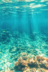 Obraz premium Underwater coral reef with sunbeams turquoise blue ocean water and colorful fish