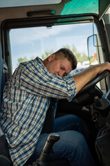 Tired truck driver sleeping on the wheel 