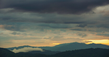 Scenic view dramatic beautiful sunset sky. Natural Sunset Sunrise on meadow silhouette shadow dark land. Vibrant dramatic sky on sunset, dawn, sunrise in Countryside. Landscape Colorful Sky At Sunset