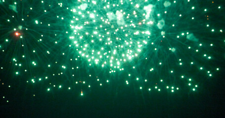 Blurred background Green Firework celebrate anniversary happy new year 2025, 4th of july holiday festival. Blurry Green firework night time celebrate national holiday. Countdown new year 2025 festive