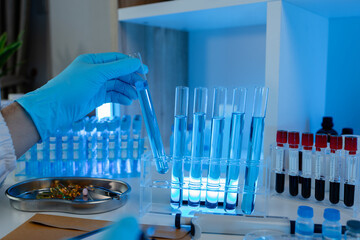 a researcher is conducting scientific experiments on a liquid substance, a scientist is using laboratory equipment to analyze a liquid sample, chemicals are tested in a lab