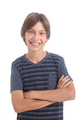 portrait of a laughing teenage boy with arms crossed on white background