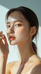 Beautiful Asian woman applying serum, with key ingredients like hyaluronic acid, vitamin C, and niacinamide for hydration and rejuvenation, solid white background.