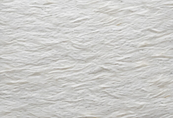 A close-up view of a marble or paper surface featuring intricate veining patterns in shades of white and beige. The texture is smooth and polished.