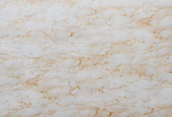 A close-up view of a marble or paper surface featuring intricate veining patterns in shades of white and beige. The texture is smooth and polished.