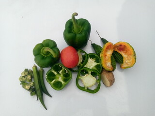A pile of different vegetables on a white background