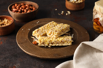 Granola bars in a wooden bowl on a dark background