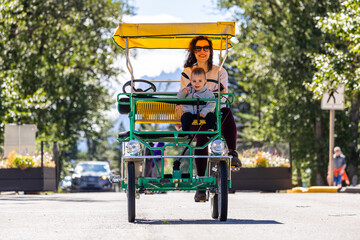 Mother and Child Enjoy a Bicycle Ride in Waterton, Alberta on a Sunny Day