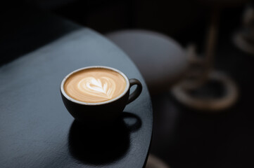 a cup of latte with a heart on the top