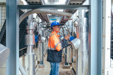 technician carefully inspecting a section of pipeline during a construction project, emphasizing safety and precision in infrastructure development.