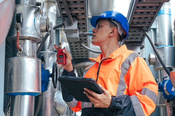 technician carefully inspecting a section of pipeline during a construction project, emphasizing safety and precision in infrastructure development.