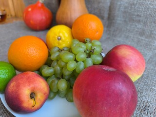 Assorted fruits and vegetables on a white plate. high-quality photo