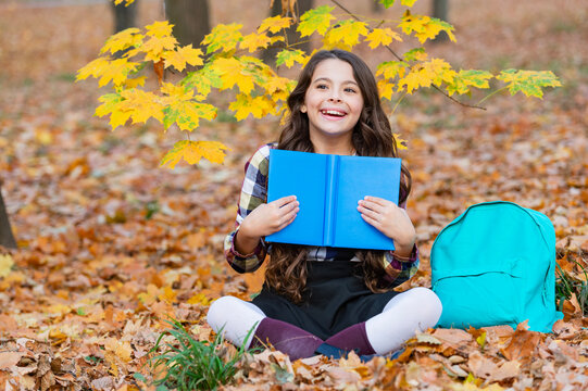 School education. School girl reading book outdoor. Teen girl reading in the autumn park. Education and knowledge. Knowledge day. Self education. Autumn book. Back to school. Happy childhood