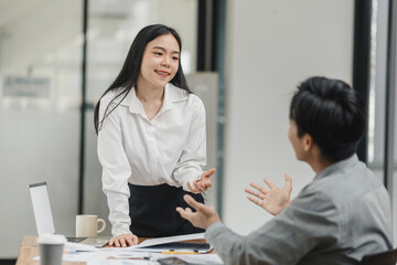 Business financial advisory services concept. Business teamwork and working on digital laptop computer with advisor showing plan of investment to clients at table office. Digital marketing.