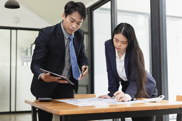 Business financial advisory services concept. Business teamwork and working on digital laptop computer with advisor showing plan of investment to clients at table office. Digital marketing.