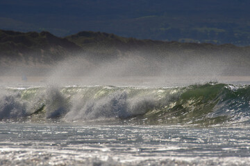 yellowish waves against a blue sky. 