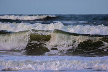 yellowish waves against a blue sky. 