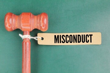 the judge's gavel and a paper tag with the word misconduct. employee or student fault concept